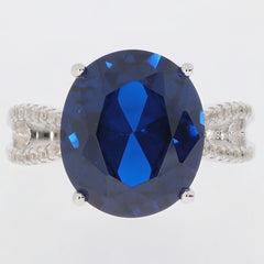 Elegant oval blue sapphire ring in sterling silver setting, showcasing a brilliant gemstone for a touch of luxury.