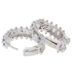 Sterling silver earrings featuring oval purple sapphires and intricate detailing, a luxurious accessory for elegance.