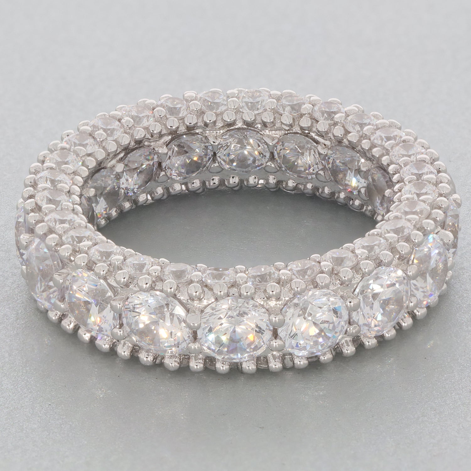 Elegant white moissanite sterling silver ring with sparkling accents, showcasing luxury and brilliance.