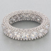 Elegant white moissanite sterling silver ring with sparkling accents, showcasing luxury and brilliance.