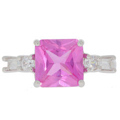 Emerald cut pink sapphire sterling silver ring with accent stones, showcasing vibrant color and elegant design.