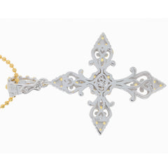 Intricate silver pendant with decorative filigree and yellow gold accents, showcasing a unique cross design.