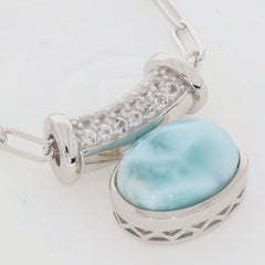 Oval blue Larimar Pectolite sterling silver pendant with sparkling accents, showcasing elegant craftsmanship.