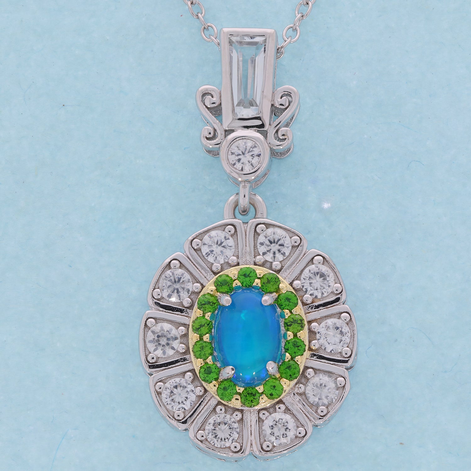 Oval blue opal sterling silver pendant with accent gemstones, elegant jewelry for a sophisticated collection.