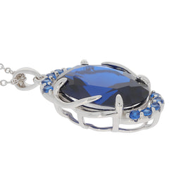 Oval blue sapphire sterling silver pendant with sparkling accent stones, elegant jewelry piece.