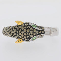 Unique animal-shaped ring with textured black and gold design, featuring green gemstone accents.