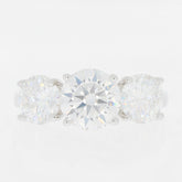 Elegant three-stone ring featuring brilliant round cut diamonds set in white gold, perfect for any occasion.
