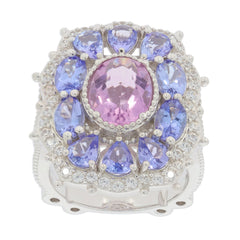 Oval pink topaz sterling silver ring surrounded by blue gemstones, showcasing elegance and luxury.