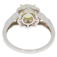 Elegant Green Peridot ring in 14K white gold setting, featuring a sparkling diamond accent, viewed from the side.