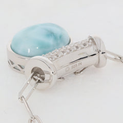 Oval blue Larimar Pectolite sterling silver pendant showcasing a sparkling gemstone accent.