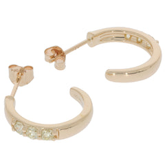 Round green diamond 14K yellow gold earrings with sparkling accents, ideal for elegant styles and luxury occasions.