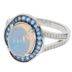 Oval white opal sterling silver ring with blue gemstone accents, showcasing luxury and elegance.