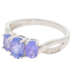 Oval blue tanzanite sterling silver ring with accent gemstones, showcasing elegance and luxury in design.