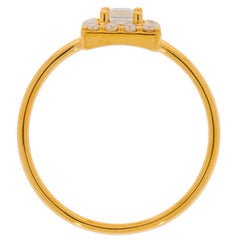 Elegant yellow gold ring with a clear gemstone, showcasing a sleek band design from a side view.