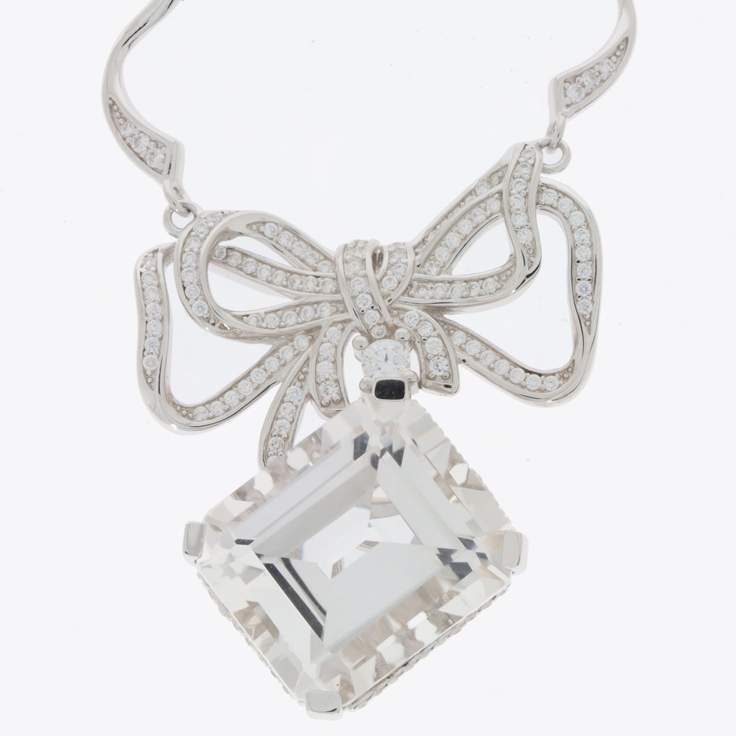 Elegant silver necklace with a bow design and a large square gemstone pendant.