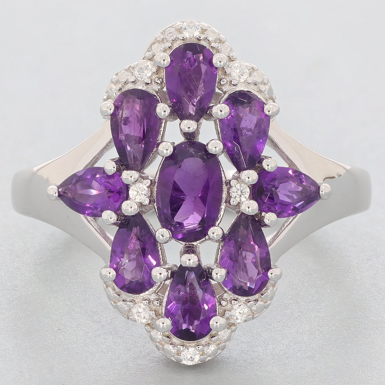 Elegant sterling silver ring featuring oval and pear-shaped purple amethyst gemstones, ideal for luxurious style.