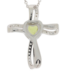 Silver cross pendant with heart-shaped yellow gemstone centerpiece, stylish and elegant jewelry piece.