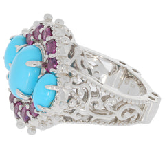 Elegant oval blue turquoise sterling silver ring with ruby accents, showcasing intricate detailing and luxury style.