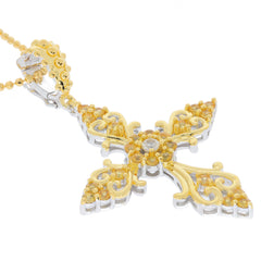 Elegant yellow gemstone cross pendant in silver and gold, showcasing intricate designs and sparkling details.
