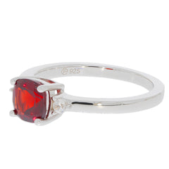 Cushion red garnet sterling silver ring with moissanite accent, elegant jewelry piece showcasing luxury and sophistication.