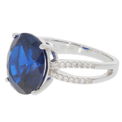 Oval blue sapphire sterling silver ring with accent diamonds, showcasing elegance and luxury.