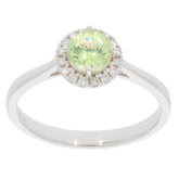 Green Peridot Sterling Silver Ring with Moissanite accents, showcasing a round cut gemstone in an elegant design.