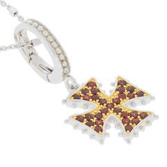 Elegant sterling silver pendant featuring red ruby gemstones in a cross design, perfect for adding luxury to any outfit.