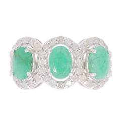 Sterling silver ring featuring three oval green emeralds accented with sparkling gemstones.