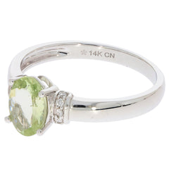 14K white gold ring featuring a green peridot gemstone and diamond accents, ideal for elegant jewelry collections.