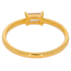 Elegant gold ring featuring a prominent emerald-cut gemstone at the center, showcasing exquisite craftsmanship.