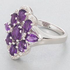 Elegant floral design ring featuring multiple oval and pear-shaped purple amethyst stones set in sterling silver.