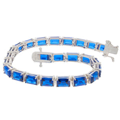 Custom sterling silver semi mount tennis bracelet setting with emerald cut blue gemstones, made to order.