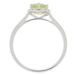 Green peridot sterling silver ring with moissanite accent, showcasing the elegant setting and sparkling gemstone from above.