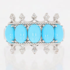 Oval blue turquoise sterling silver ring with intricate design, featuring five vibrant turquoise stones.