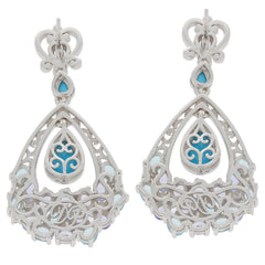 Elegant Pear Blue Turquoise Sterling Silver Earrings with intricate design and Topaz accents.