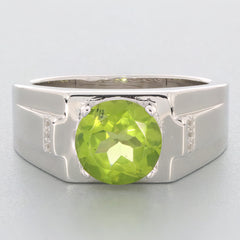 Round green peridot gemstone set in a sterling silver ring, showcasing elegant accents for a luxurious look.