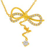 Gold necklace with a bow design and sparkling diamonds, featuring a heart-shaped gemstone pendant.