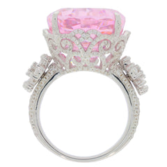 Oval pink sapphire sterling silver ring with intricate design and accent stones, radiating elegance and luxury.