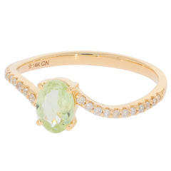 14K yellow gold ring featuring an oval green peridot and diamond accents, perfect for elegant jewelry collections.
