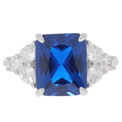 Emerald blue sapphire sterling silver ring with sparkling accent stones, perfect for elegant jewelry collections.