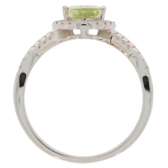 Green Peridot 14K white gold ring with diamond accent showcasing a sparkling gemstone from a side view.