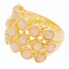 Elegant gold ring featuring multiple white opal gemstones, perfect for adding a touch of luxury to any jewelry collection.