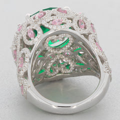 Elegant round green emerald sterling silver ring with pink accent stones and intricate design.