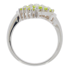 Marquise Green Peridot sterling silver ring side view showcasing intricate design and sparkling gemstones.