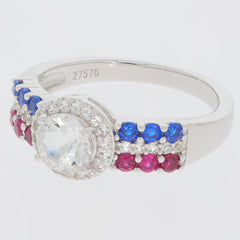 Round white Moissanite ring with blue and pink gemstone accents in sterling silver, showcasing elegance and luxury.
