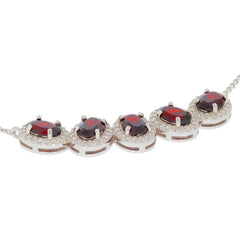 Oval red garnet sterling silver necklace with accents, showcasing elegant gemstones and a luxurious design.