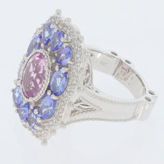 Oval pink topaz sterling silver ring surrounded by blue and clear gemstones, radiating elegance and luxury.