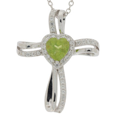 Elegant green peridot heart pendant in sterling silver with diamond accents, featuring a stylish cross design.