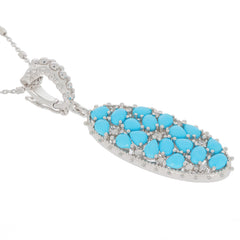 Blue turquoise sterling silver pendant featuring multiple pear-shaped stones on an elegant chain.