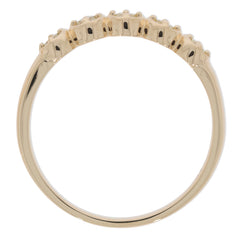 Back view of a 14K yellow gold ring with multiple diamond accents, showcasing its elegant design.